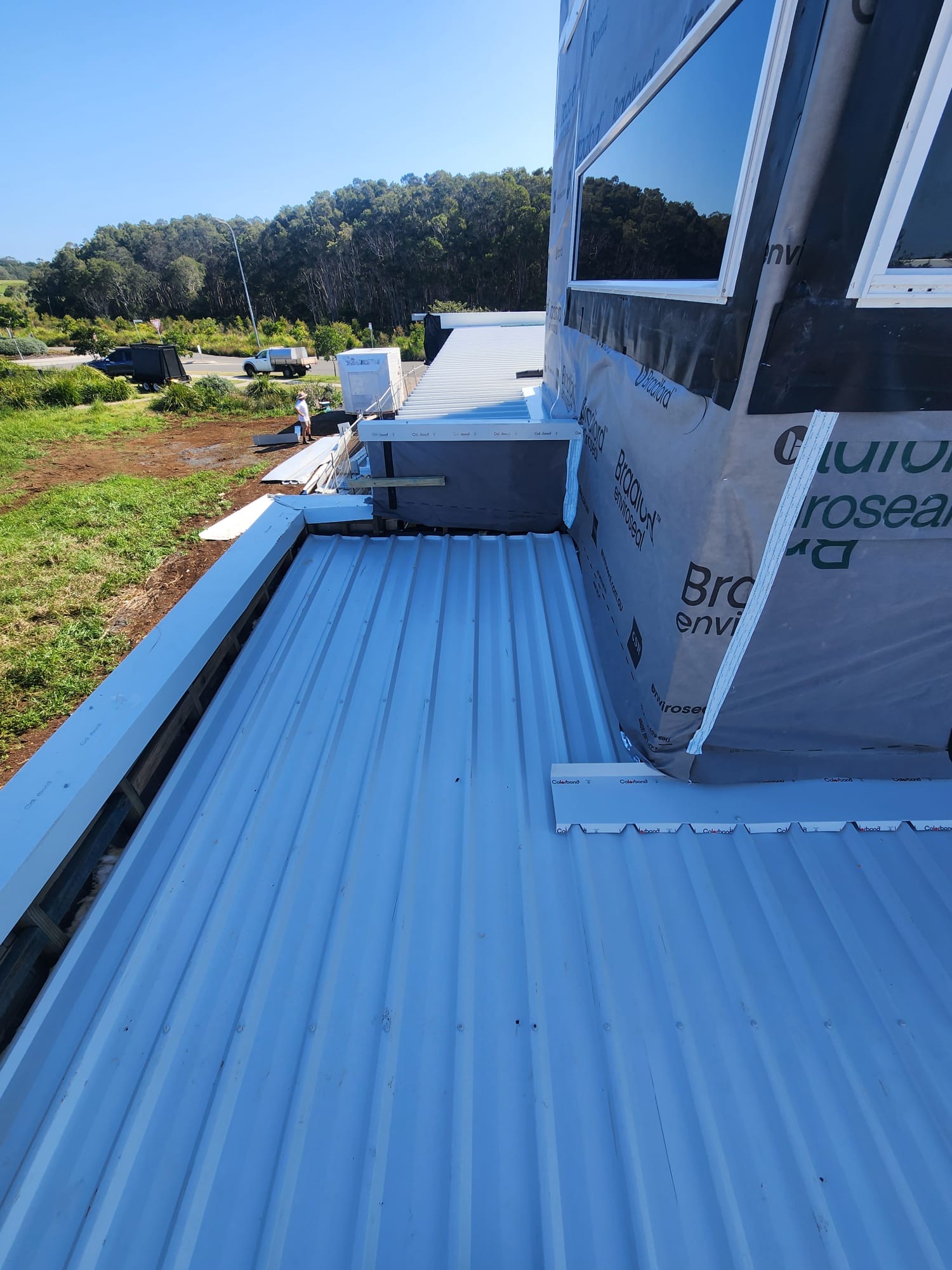 Close view of a metal roof and wall junction during construction