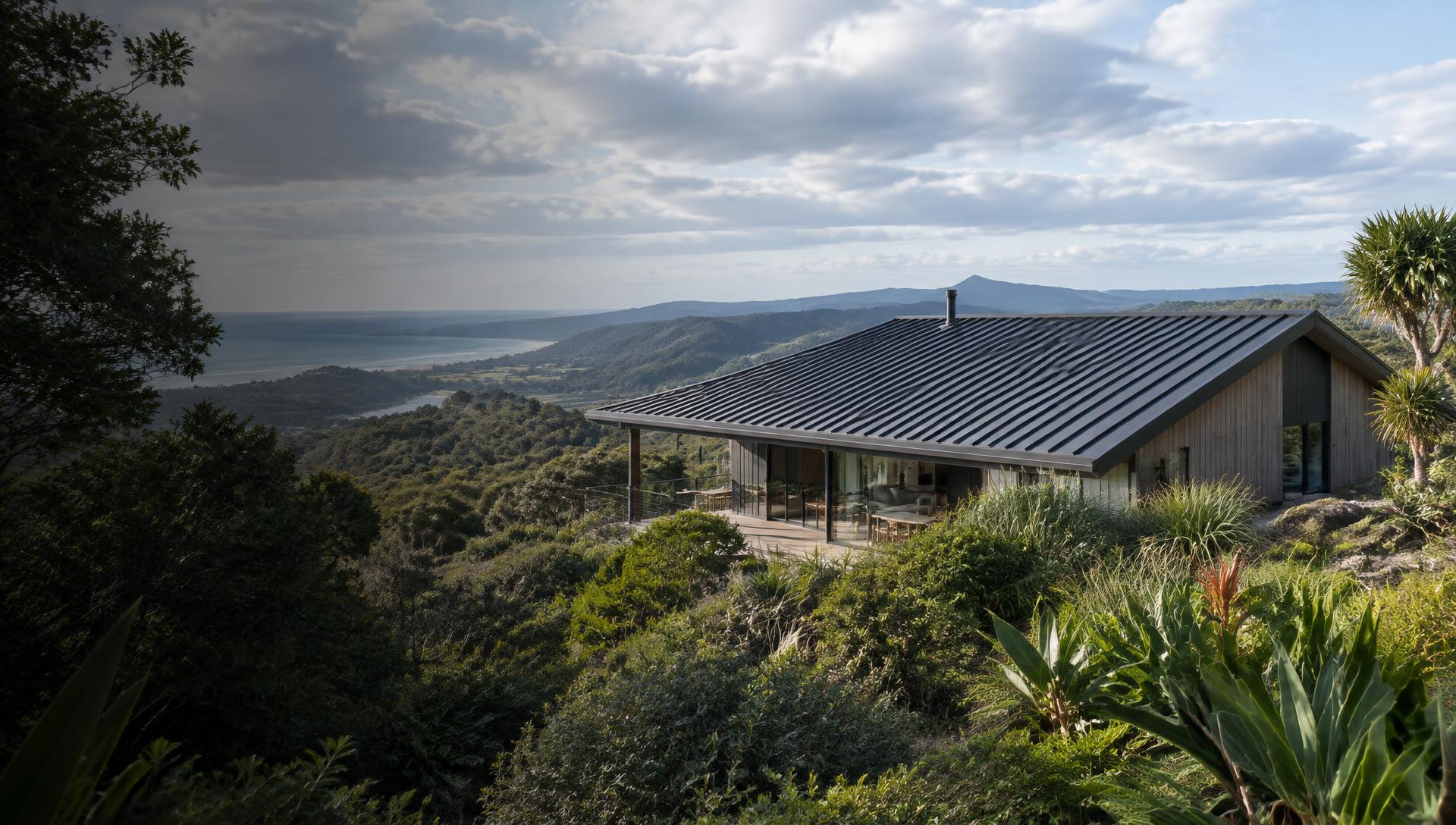 Illustrative coastal architecture with a dark metal roof among subtropical foliage
